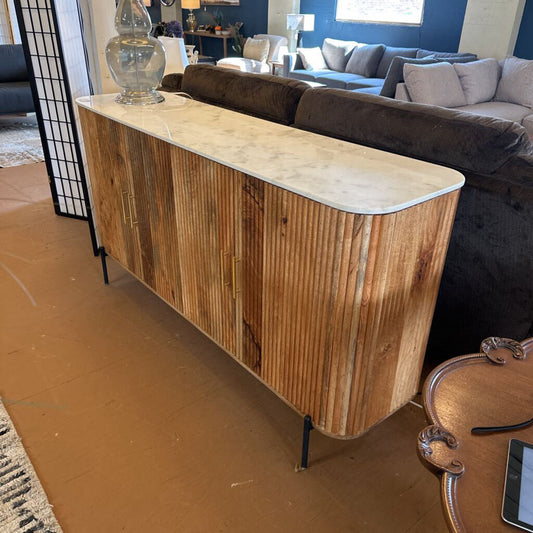 Wooden console table with marble top in a living room setting