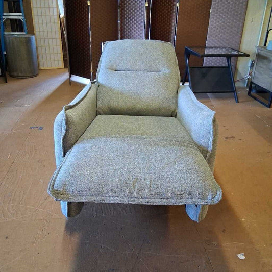 Vintage-style armchair in a room with a tiled floor and wooden furniture.