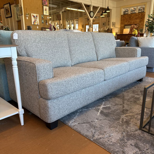 Gray sofa in a room with a rug and furniture