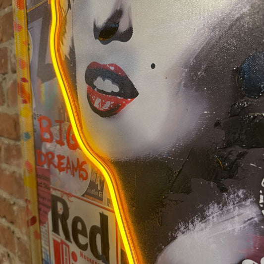 Neon sign with a stylized face design on a brick wall.