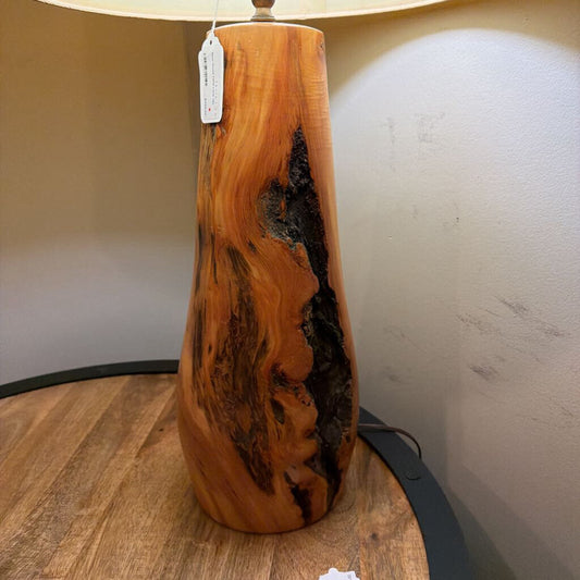 Wooden lamp with a tag on a wooden surface