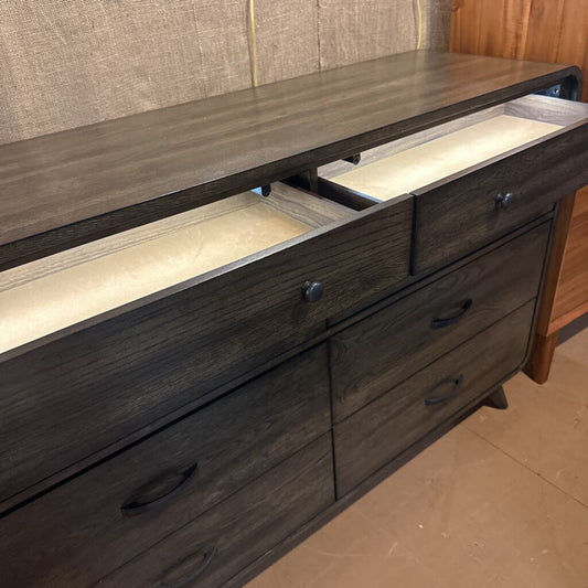 Dark wood dresser with open drawers in a room setting