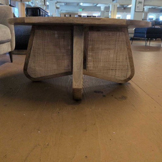 Wooden table with wicker legs in a room setting