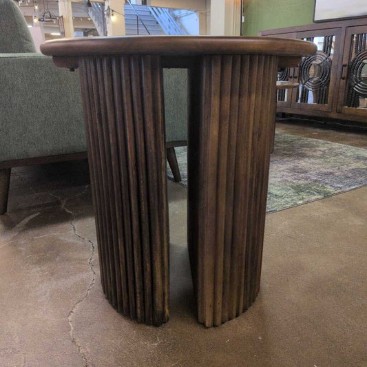 Wooden side table with ribbed design in a room setting