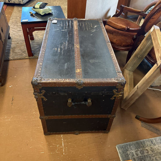 Vintage trunk on a wooden floor with furniture around