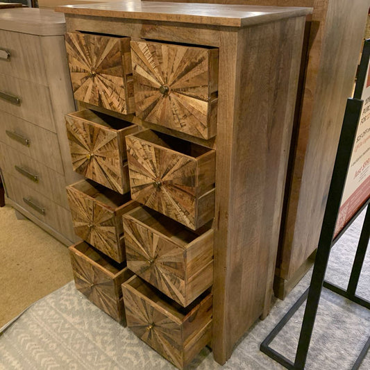 Wooden dresser with geometric drawer designs in a showroom setting