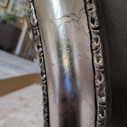 Close-up of a silver ornate object with visible scratches