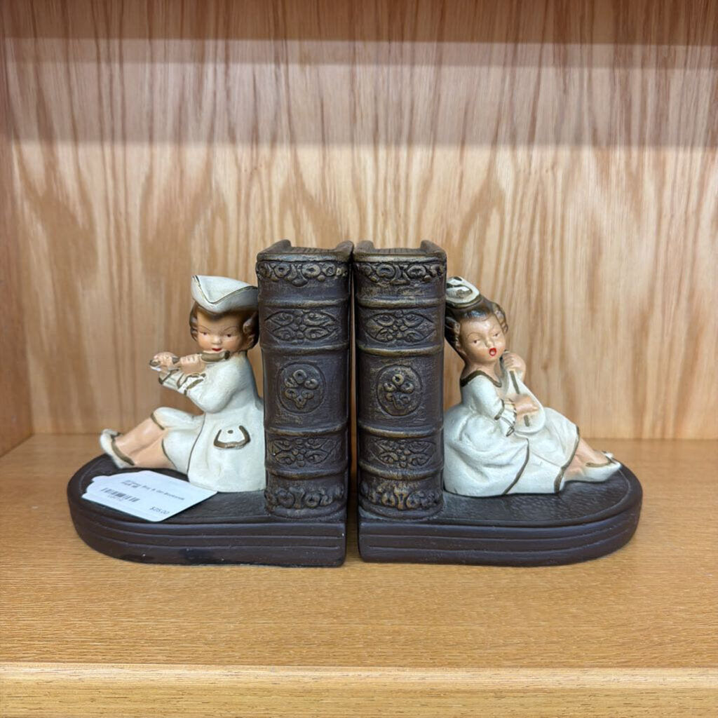 Bookends with decorative figures on a wooden surface