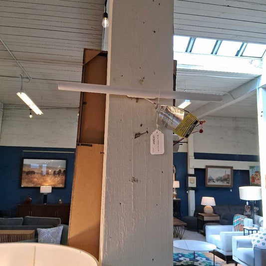 Framed artwork hanging on a wall in a room with furniture and decor.