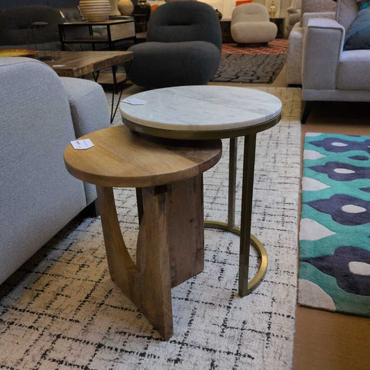 Two side tables, one wooden and one round marble top, in a living room setting.
