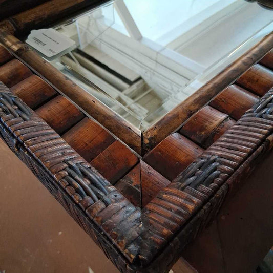 Wooden jewelry box with intricate design on a reflective surface