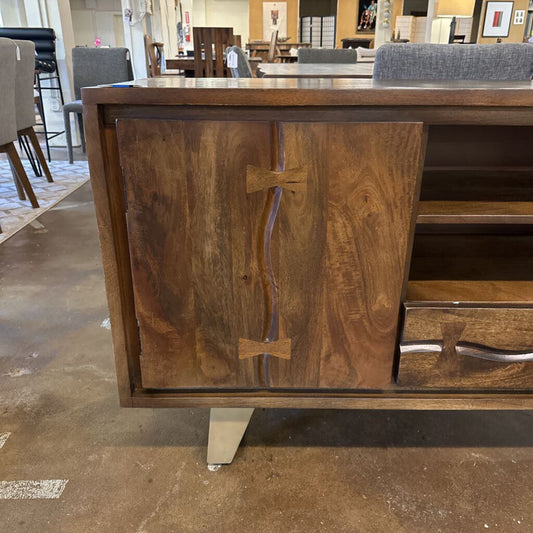 Wooden cabinet with bow tie design in a showroom setting