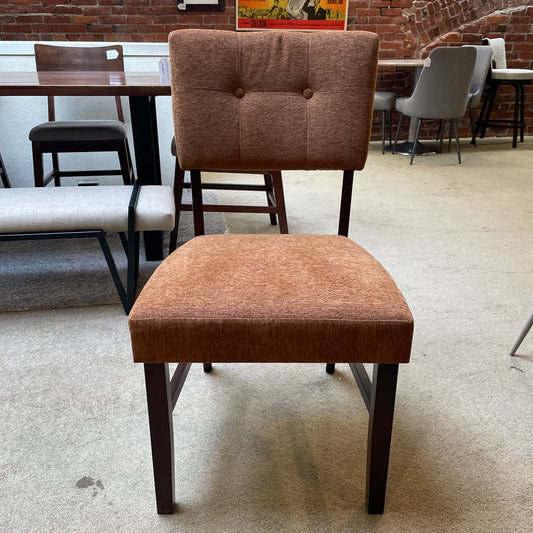 Brown upholstered chair in a room with other furniture