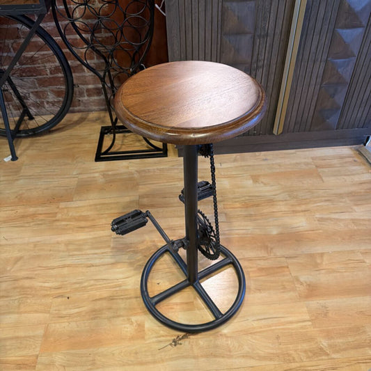 Wooden bar stool with metal adjustable mechanism on a wooden floor.