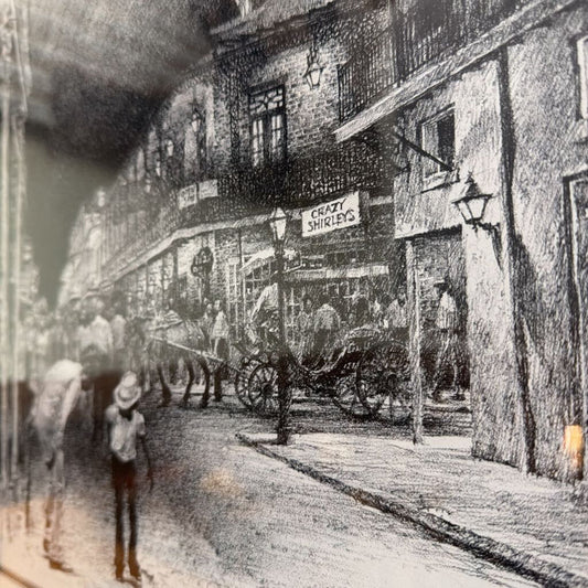 This black-and-white framed print titled "Bourbon Street New Orleans" captures a lively, nostalgic scene of the historic French Quarter