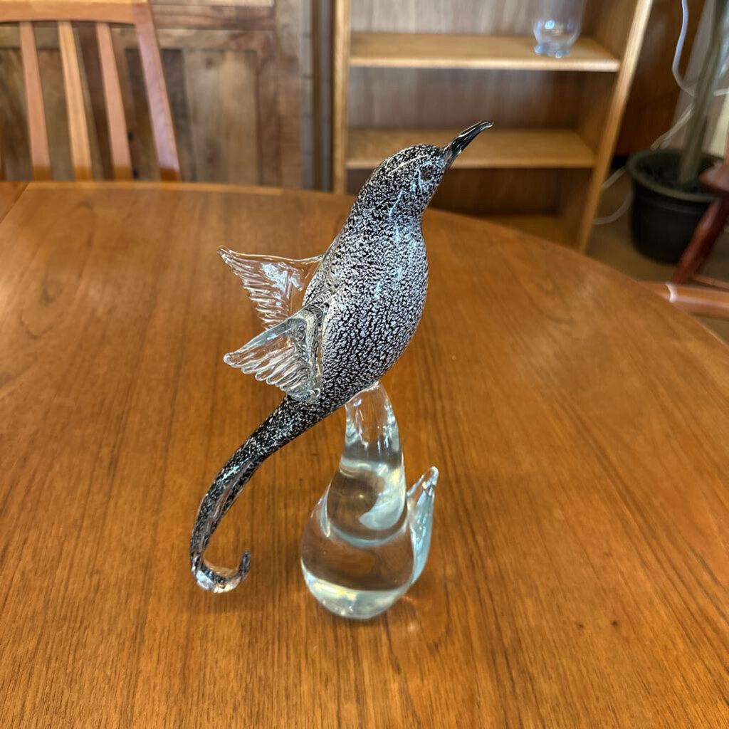 Decorative glass seahorse on a wooden table