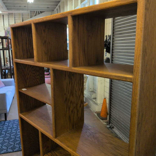 Wooden bookshelf with multiple shelves in a room setting