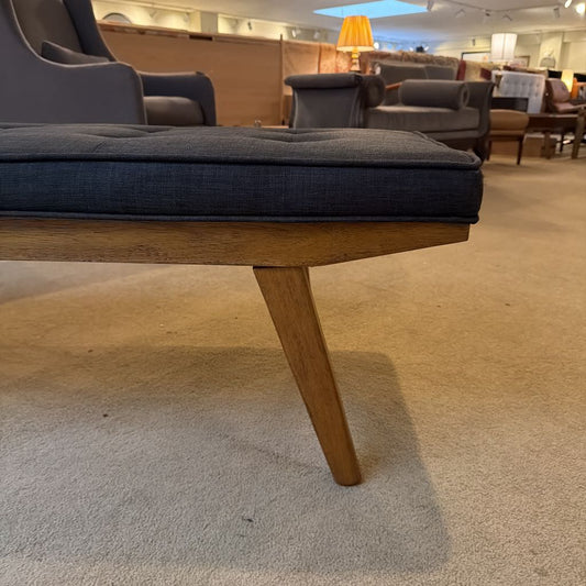 Sofa with wooden legs in a furniture store setting