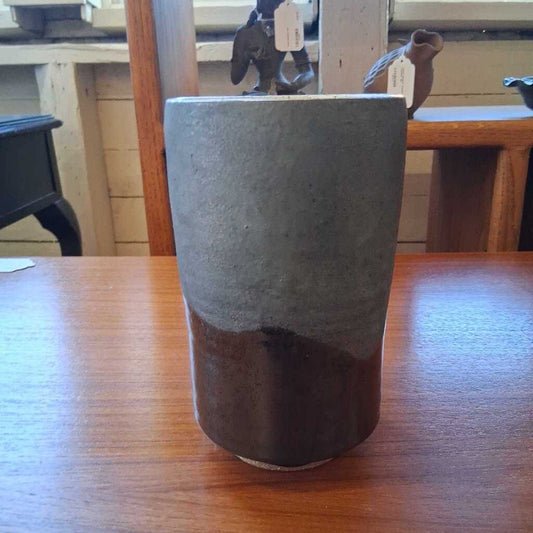Ceramic cup with two-tone design on a wooden table