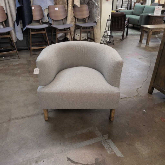 Gray armchair in a room with other furniture