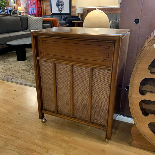 Wooden cabinet with wicker doors in a living room setting