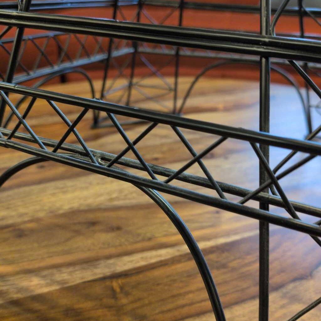 Close-up of a metal chair frame on a wooden floor