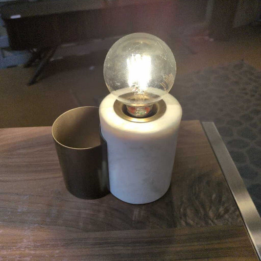 Light bulb in a decorative holder on a wooden surface