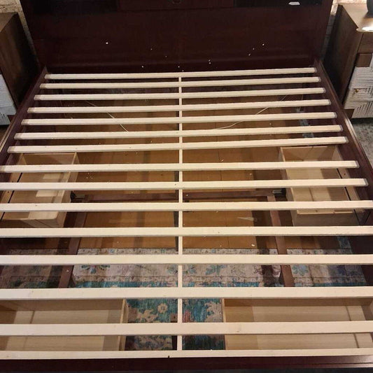Wooden bed frame with storage drawers on a patterned rug
