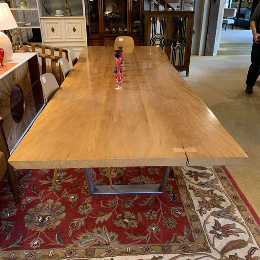 Wooden dining table with chairs in a room setting