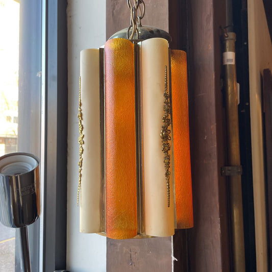 Vintage-style pendant light with orange and beige glass shades hanging in a room.