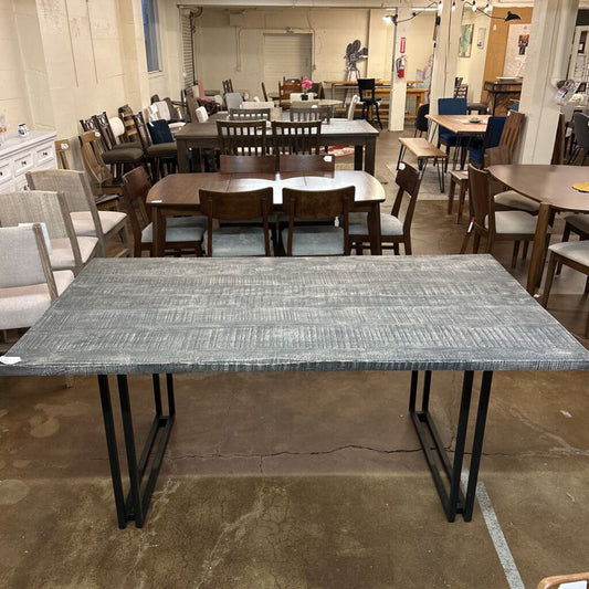 Dining room with multiple tables and chairs in a showroom setting