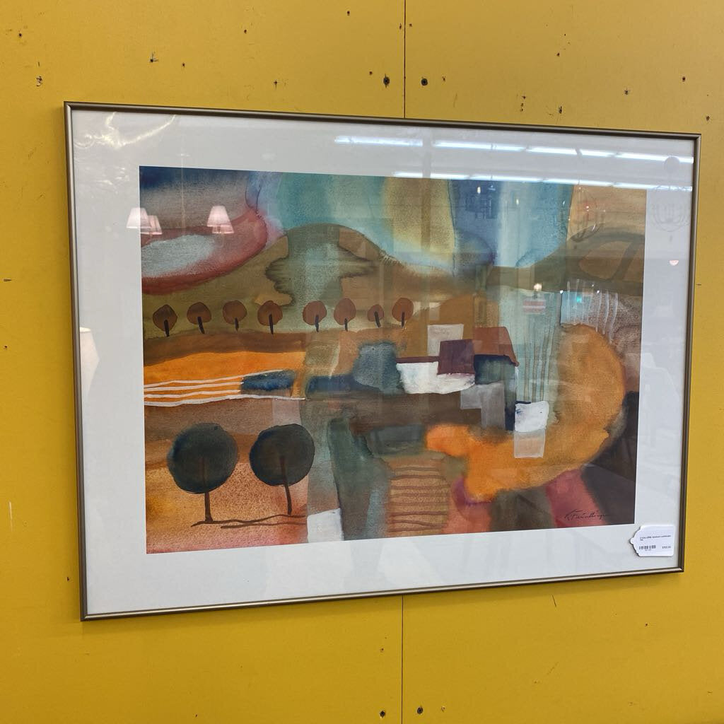 Framed abstract painting on a yellow wall