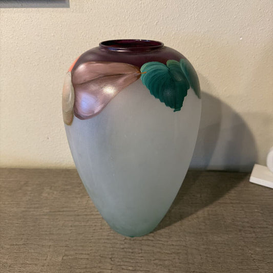 Decorative vase with floral designs on a textured surface