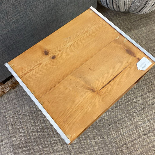 Wooden stool with a white base on a carpeted floor