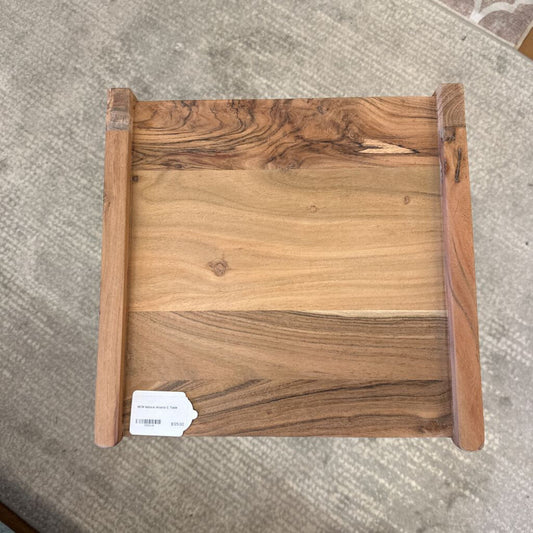 Wooden tray with a visible brand tag on a textured surface
