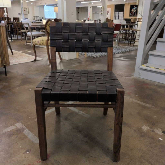 Chair with woven backrest and seat in a furniture store setting