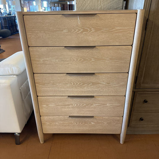 Wooden dresser with five drawers in a room setting