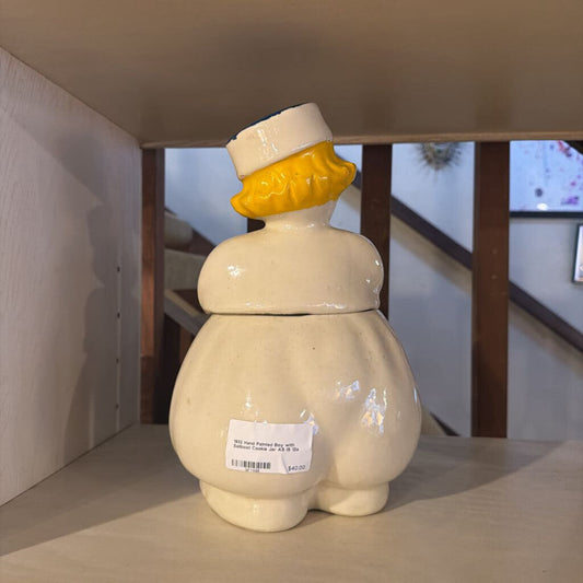 Ceramic cookie jar with a unique design on a table.