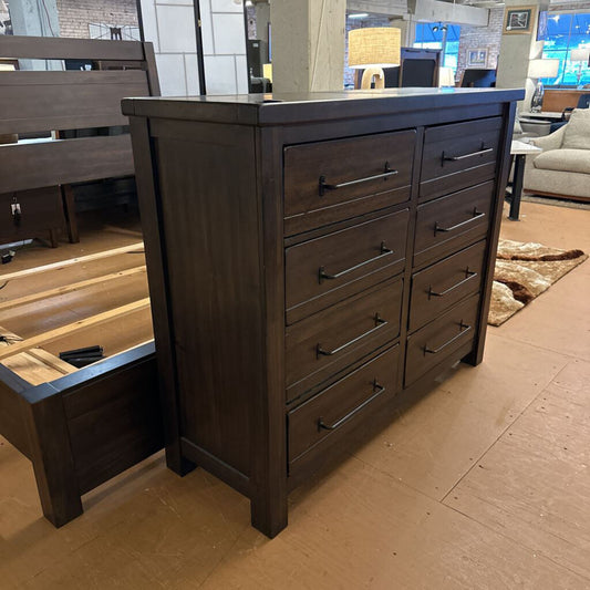 Dark wood dresser with multiple drawers in a room setting