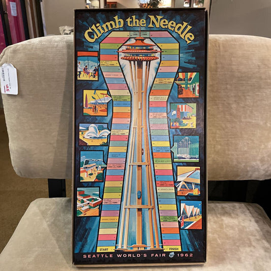 Board game box titled 'Climb the Needle' featuring the Space Needle at Seattle World's Fair 1962.