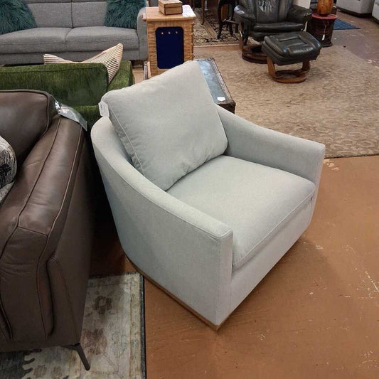 Gray armchair in a room with other furniture