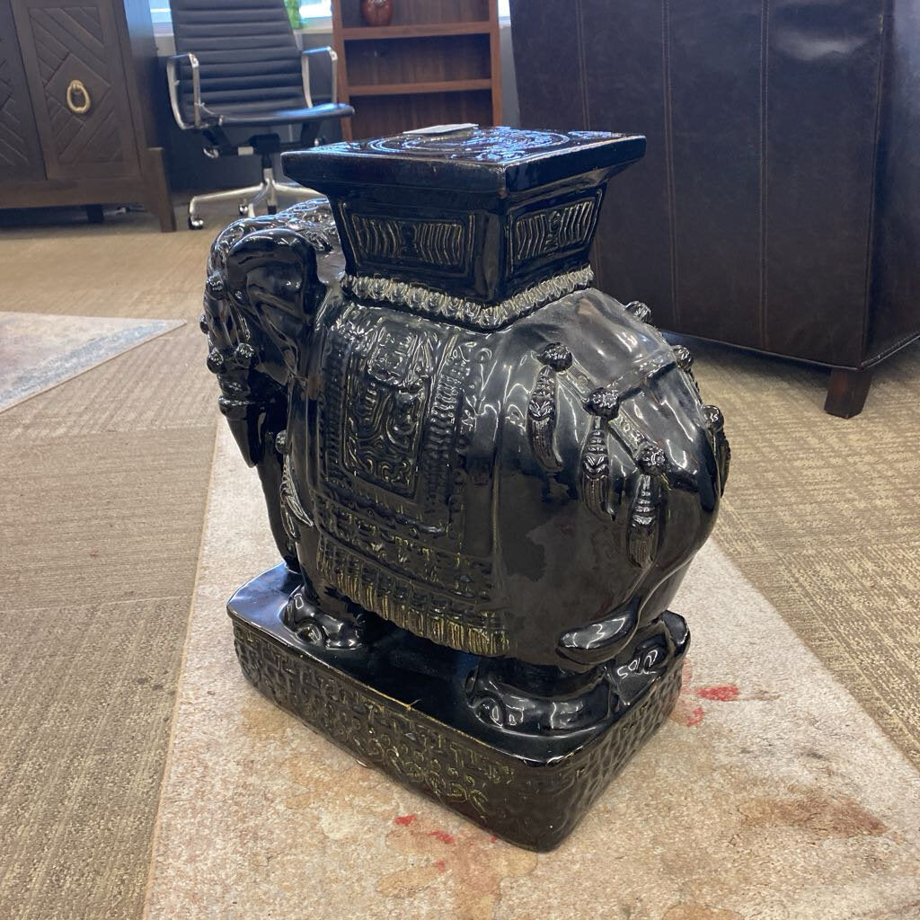 Decorative black urn on a carpeted floor in an office setting