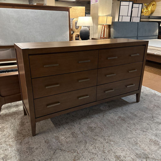 Wooden dresser with multiple drawers in a room setting