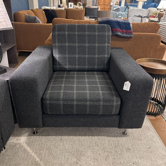 Gray plaid armchair in a furniture store setting