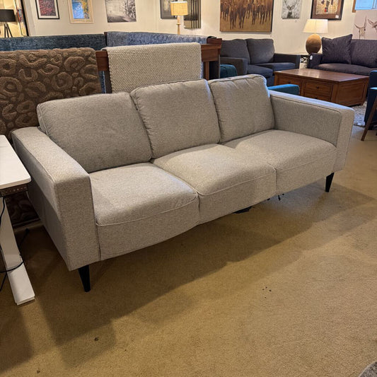 Gray sofa in a room with other furniture and decor