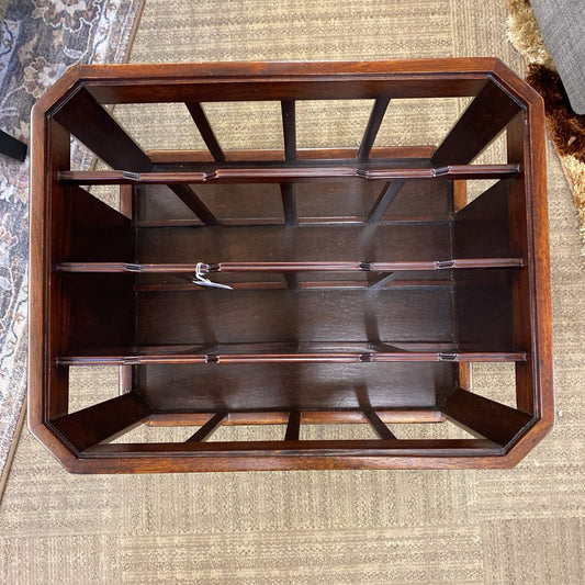 Wooden jewelry display case on a textured surface