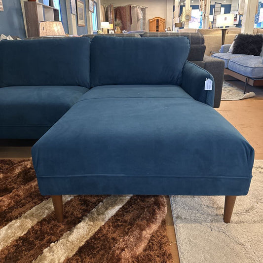Blue sectional sofa in a furniture store setting