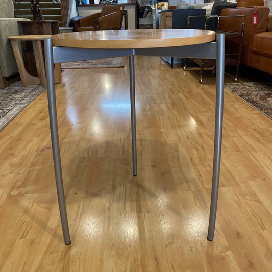 Small round table with metal legs on a wooden floor