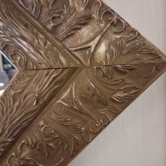 Decorative metal panel with embossed floral patterns on a plain background