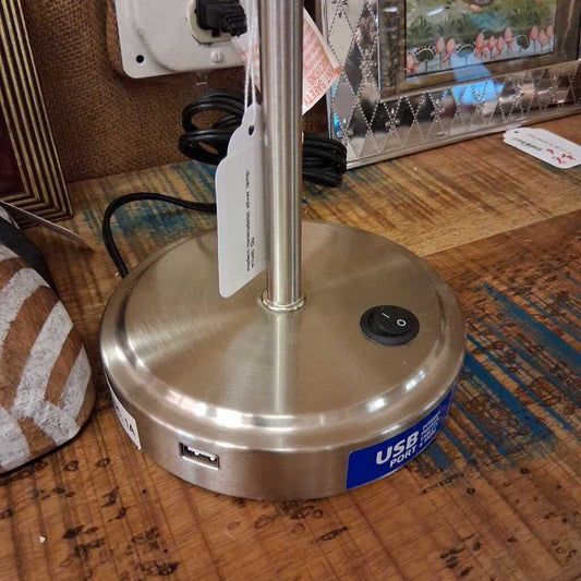 Metallic lamp with USB port on a wooden surface
